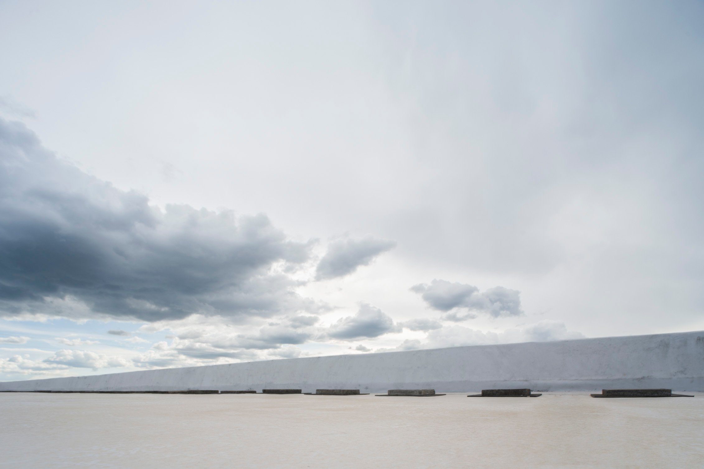 Picturepool Studios rooftop — rooftop surface with a low white wall beneath dark, overcast clouds