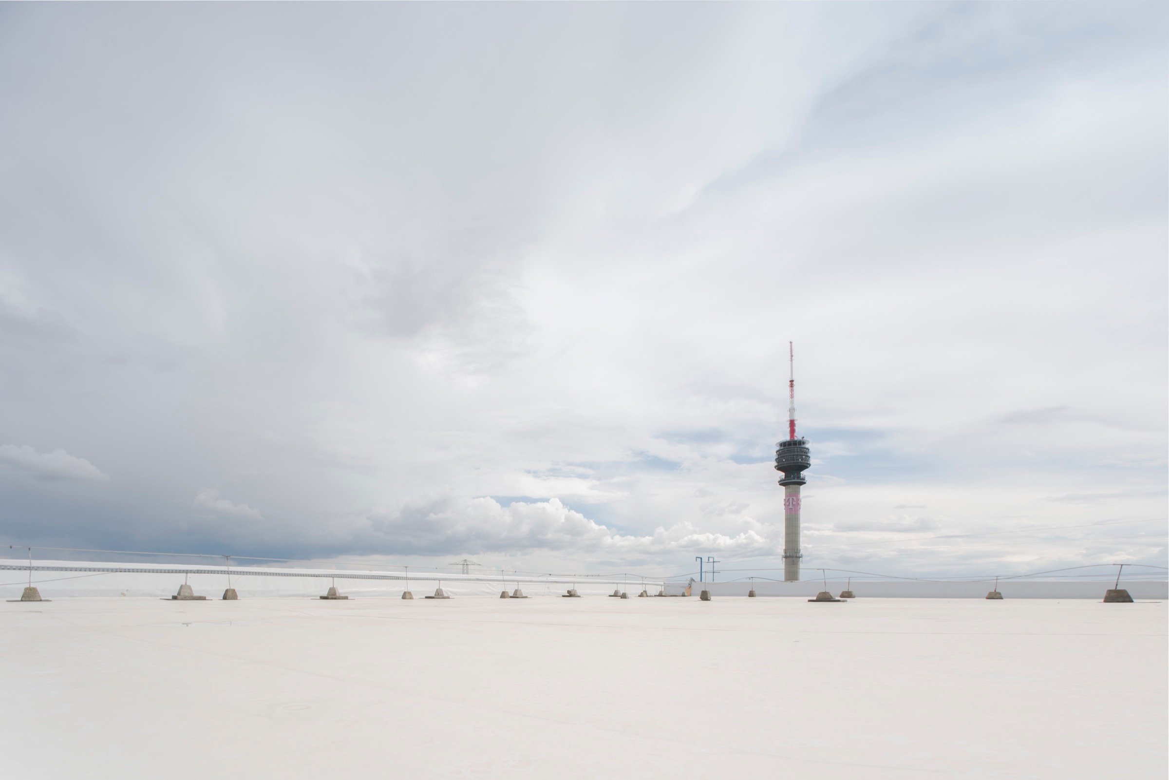 Picturepool Studios rooftop — tall telecommunications tower, a Budapest landmark, against a dramatic cloudy sky